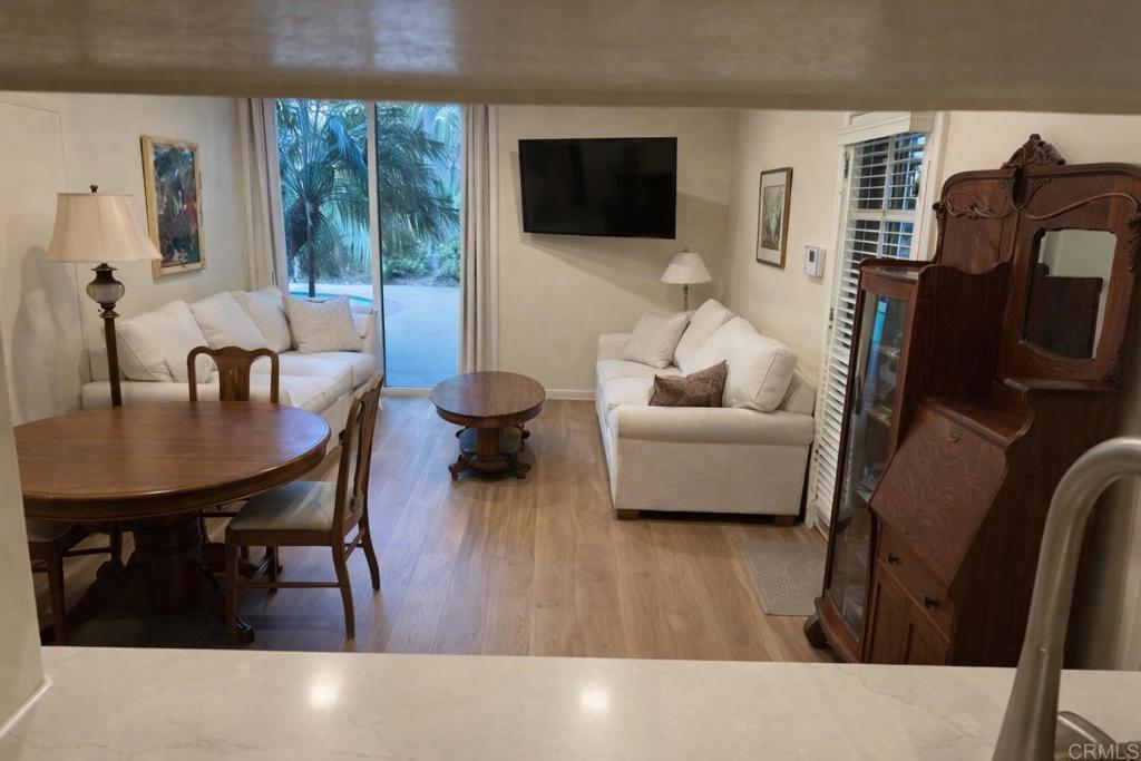 714 Passiflora Avenue, Unit 1 Encinitas, CA 92024 - Photo 2 of 14 a living room with furniture and a flat screen tv