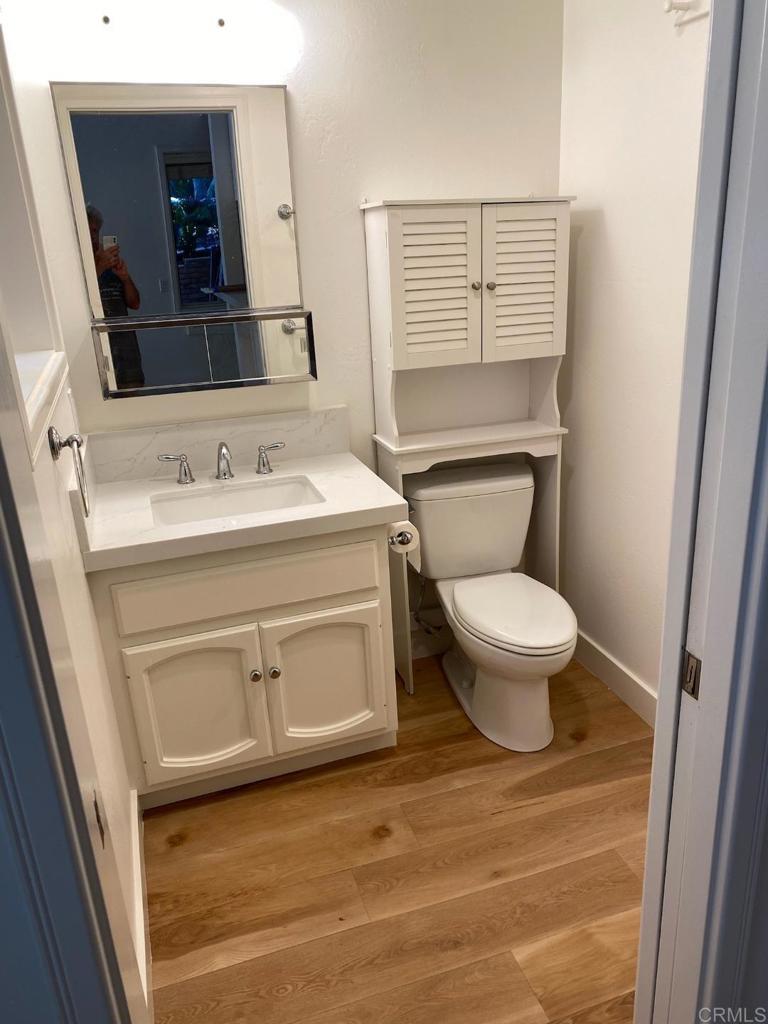 714 Passiflora Avenue, Unit 1 Encinitas, CA 92024 - Photo 5 of 14 a bathroom with a toilet sink and mirror