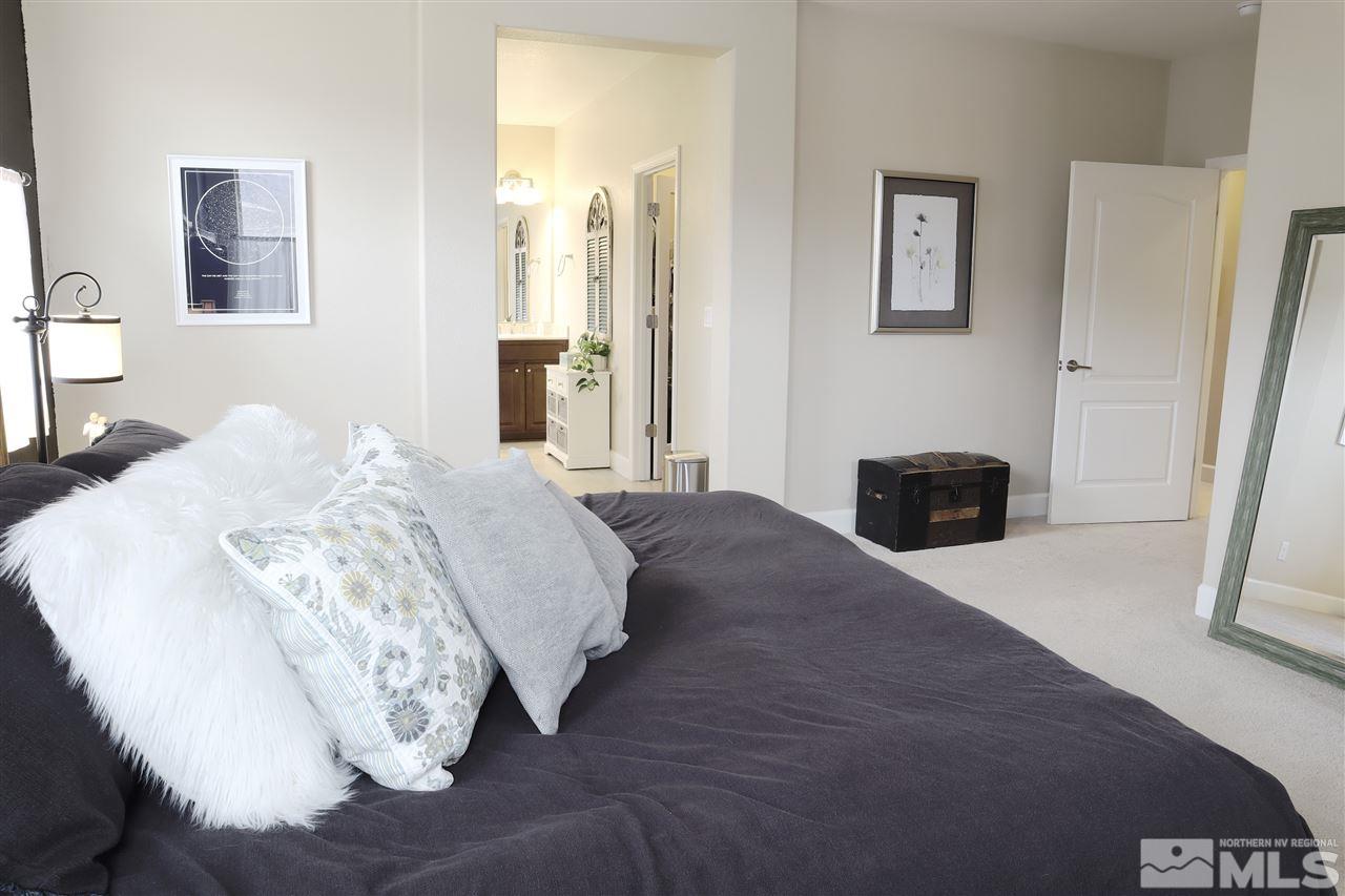 10060 Barrel Racer Drive Reno, NV 89521 - Photo 7 of 13 a spacious bedroom with a bed and a cabinets