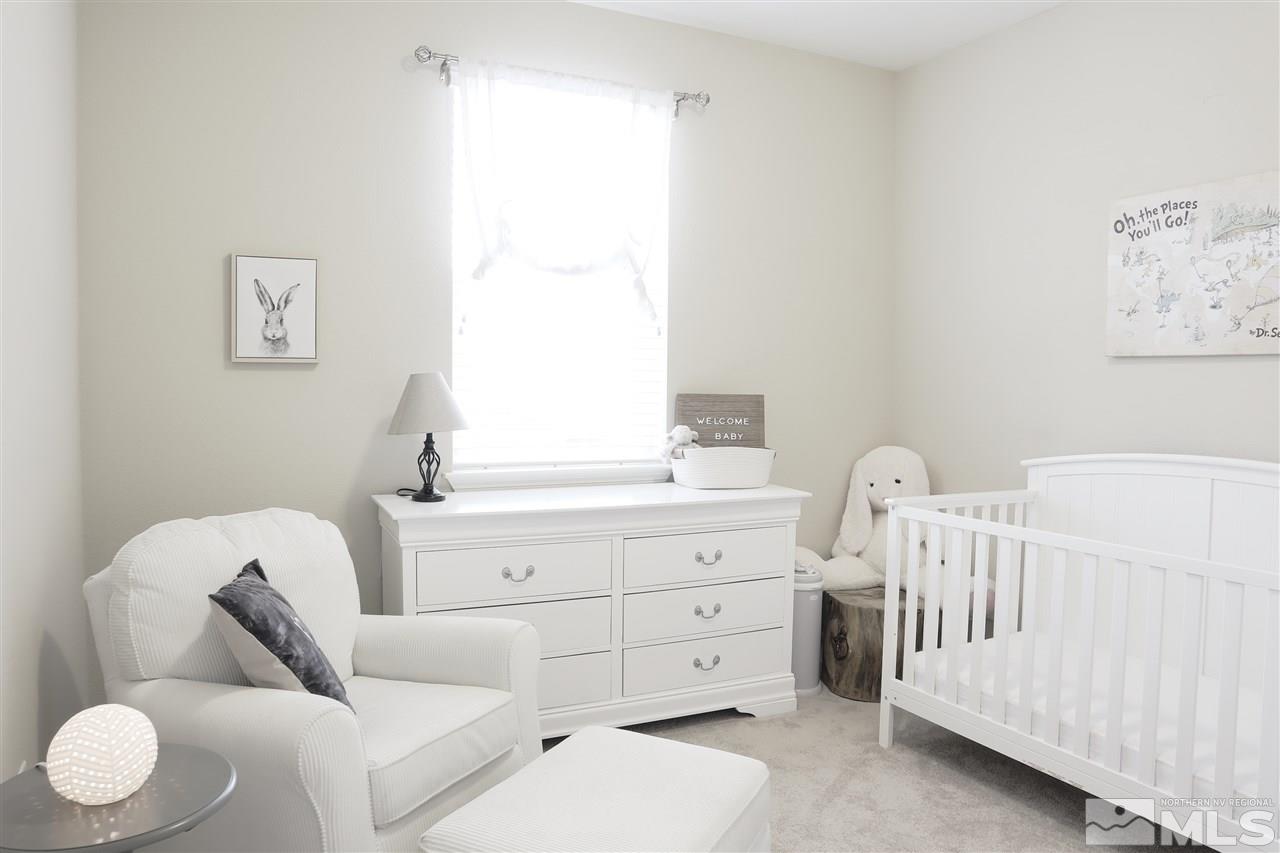 10060 Barrel Racer Drive Reno, NV 89521 - Photo 10 of 13 a bedroom with furniture and baby crib