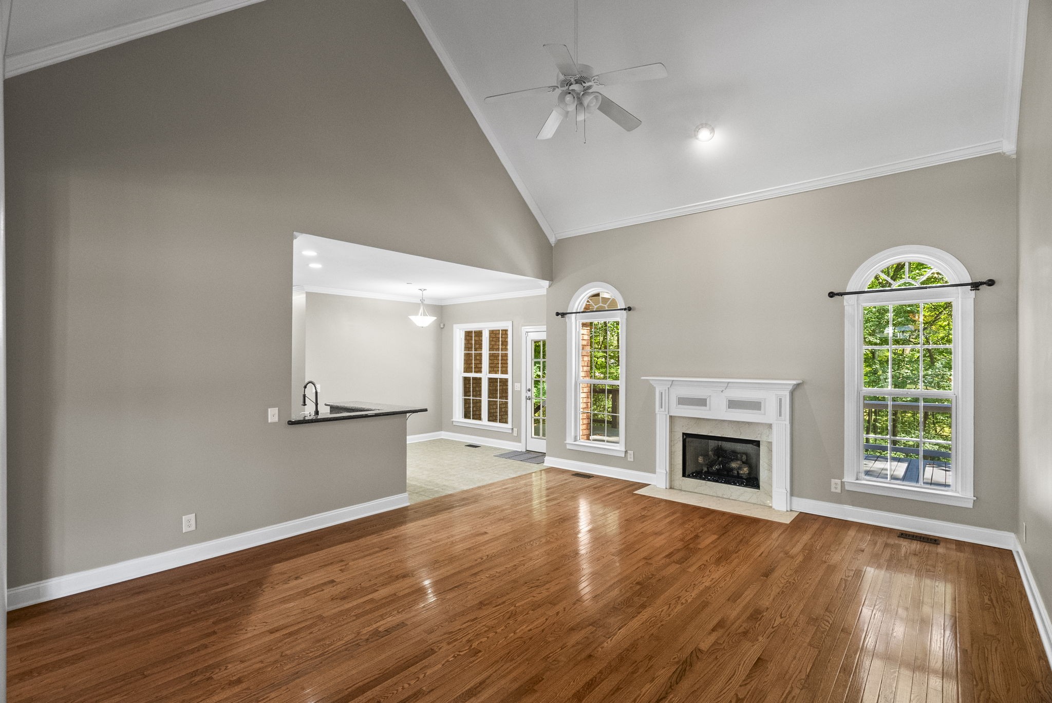205 Yearling Trace Pleasant View, TN 37146 - Photo 11 of 29 a view of empty room with wooden floor fireplace and windows