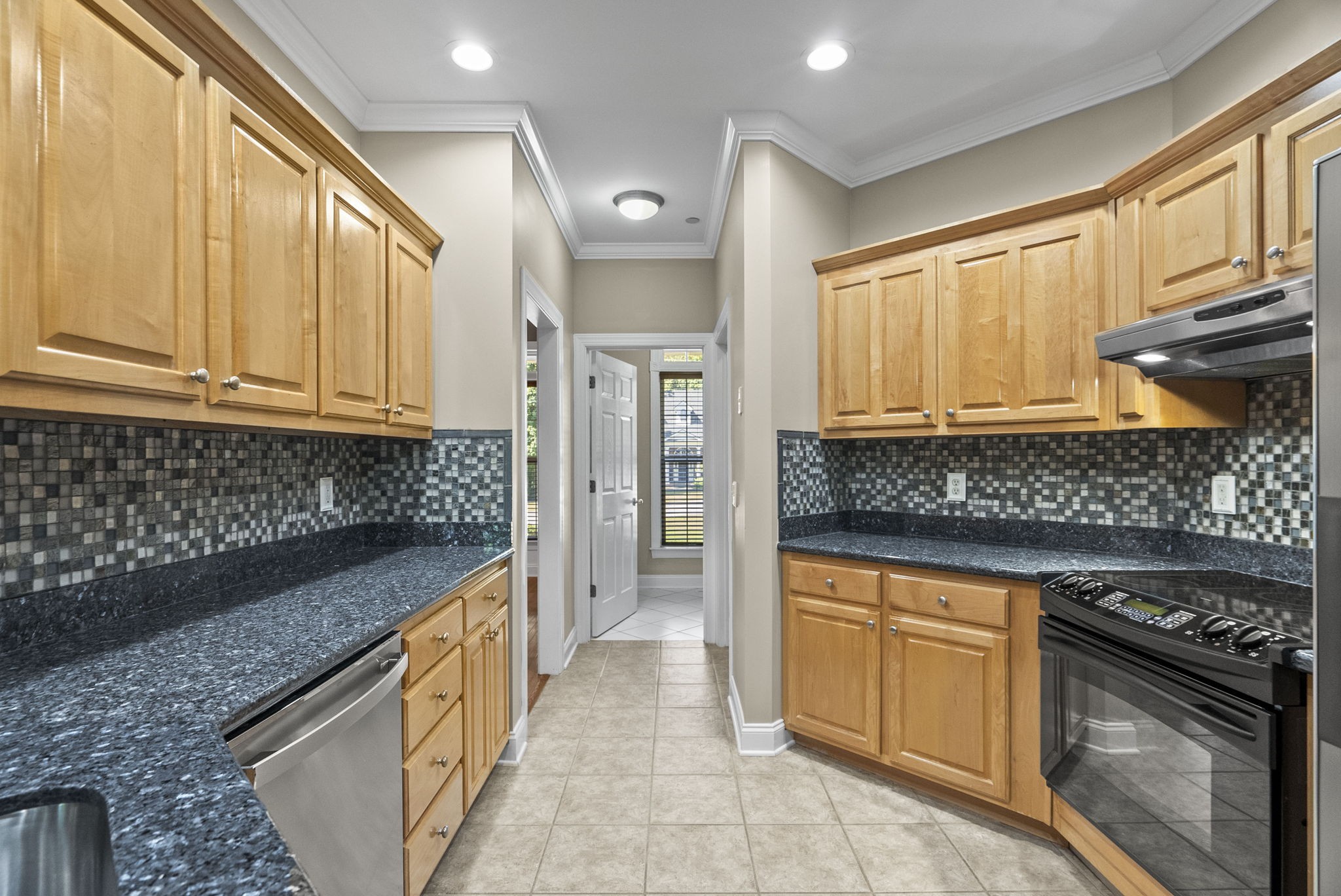 205 Yearling Trace Pleasant View, TN 37146 - Photo 14 of 29 a kitchen with stainless steel appliances granite countertop a stove a sink and a microwave