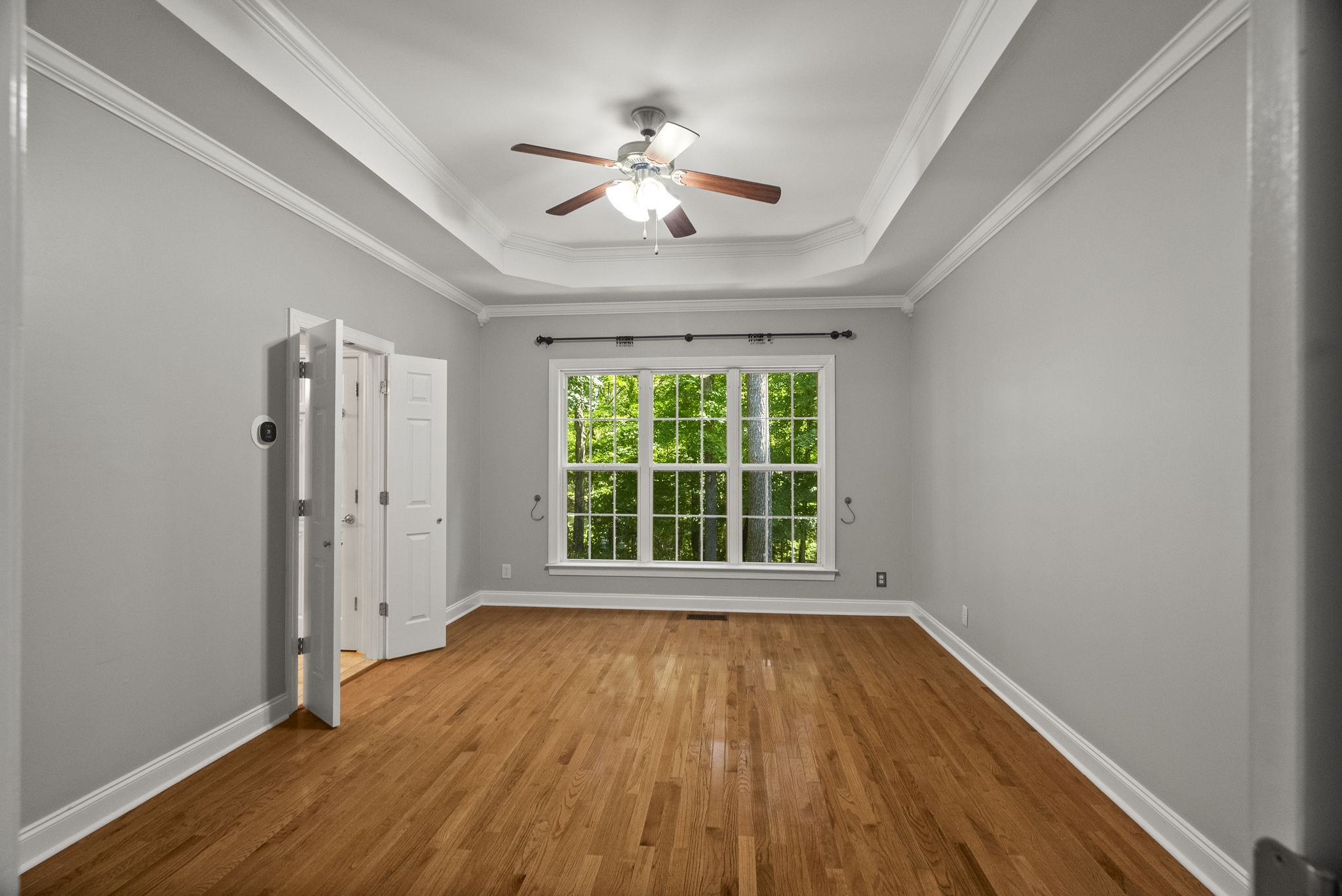 205 Yearling Trace Pleasant View, TN 37146 - Photo 17 of 29 a view of an empty room with wooden floor and a window
