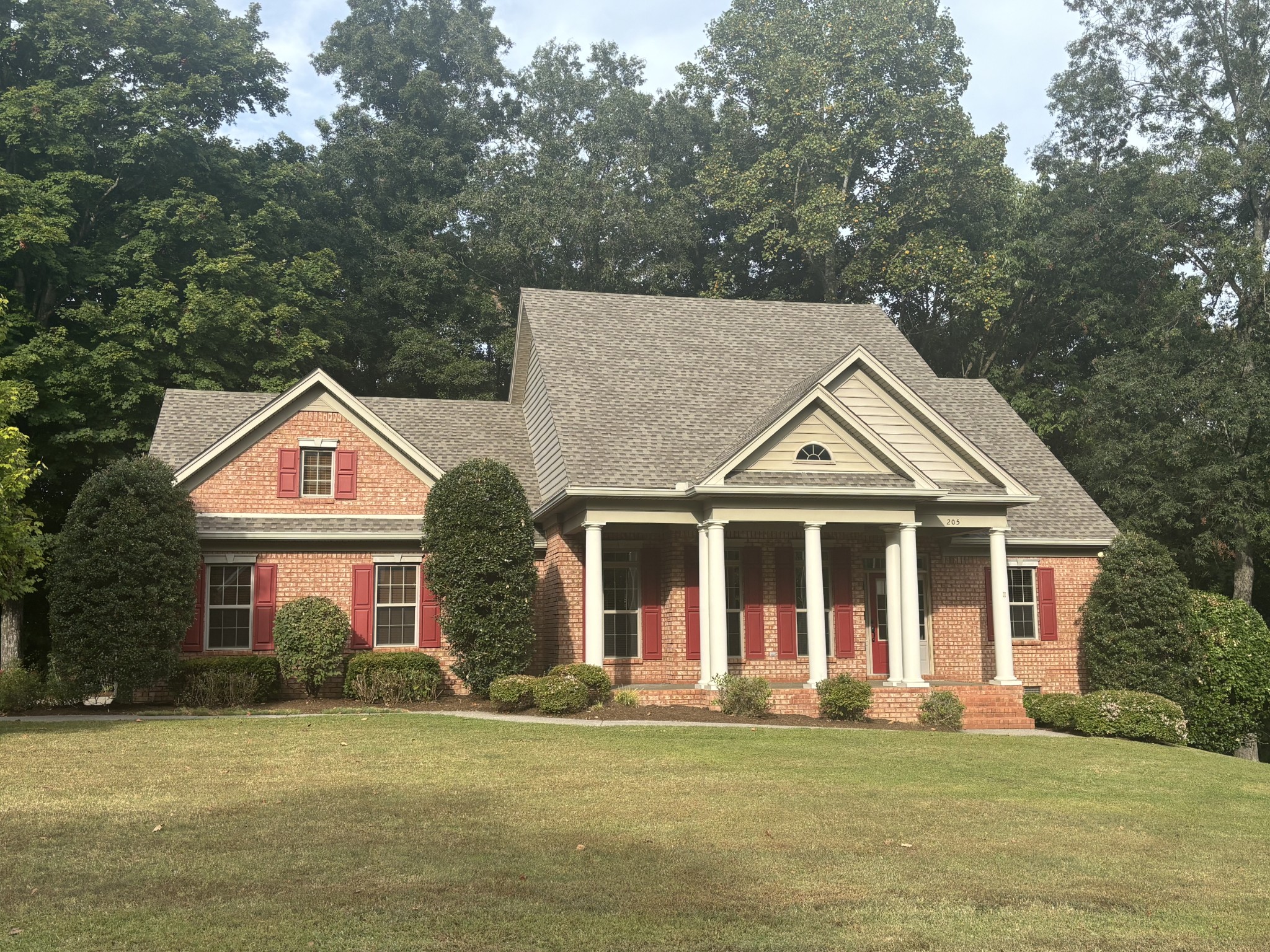 205 Yearling Trace Pleasant View, TN 37146 - Photo 2 of 29 a front view of a house with a garden and trees