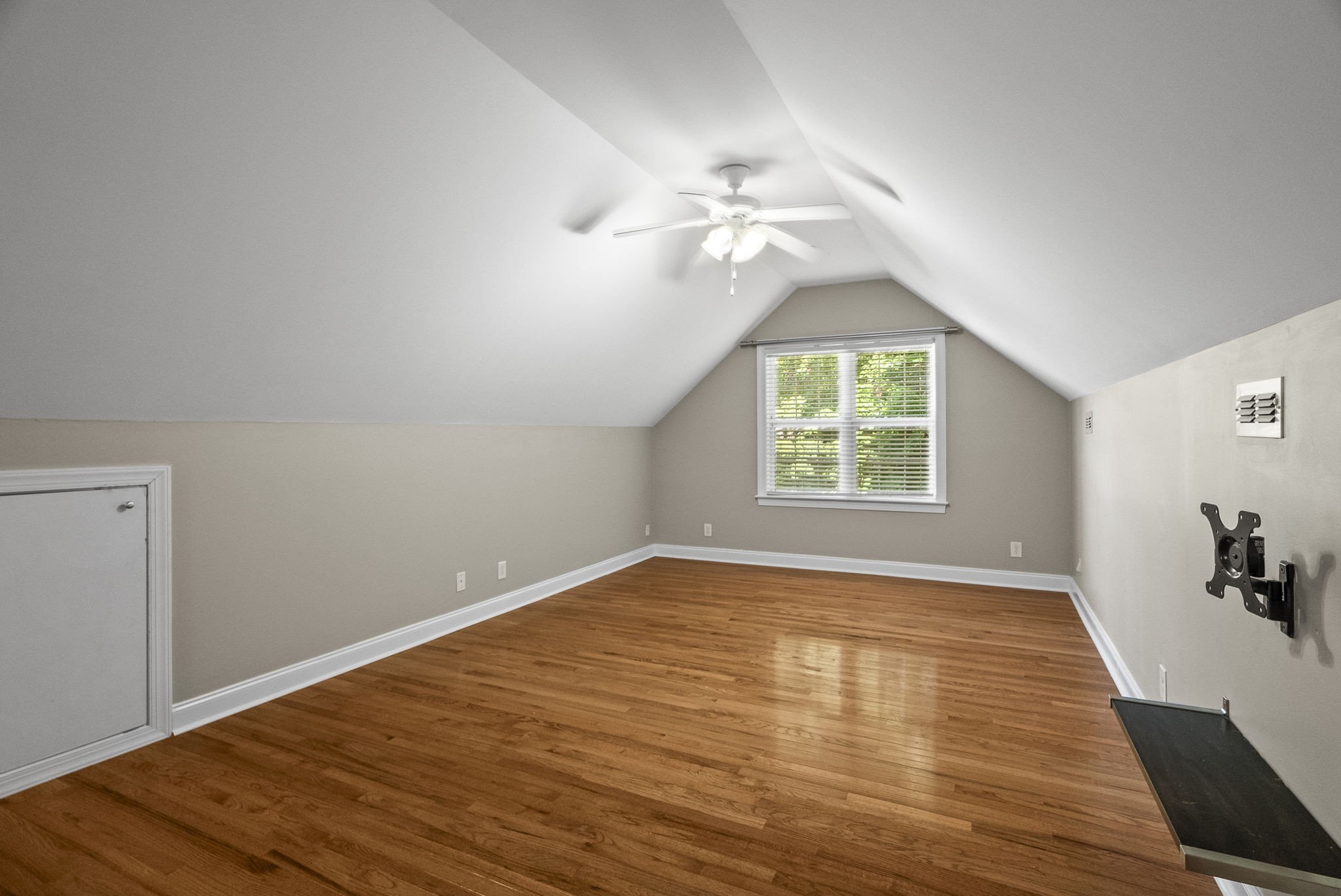 205 Yearling Trace Pleasant View, TN 37146 - Photo 25 of 29 an empty room with wooden floor chandelier fan and windows