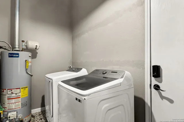 a backyard of a house with potted plants and large tree