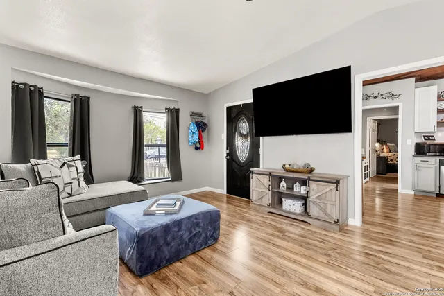 a kitchen with stainless steel appliances granite countertop a refrigerator a stove and a wooden floors