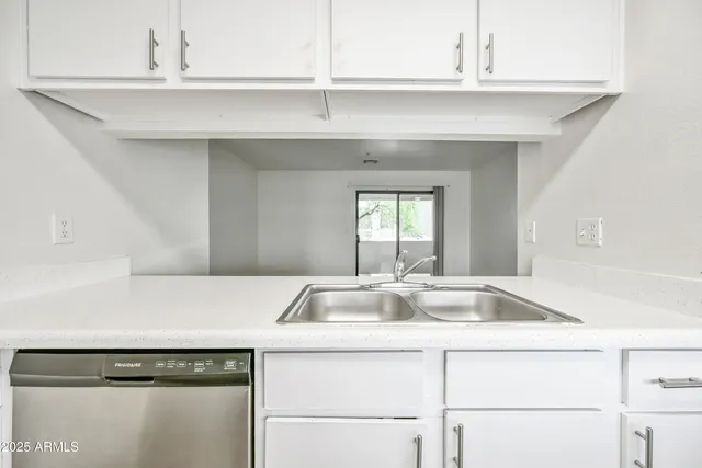 a kitchen with a sink and cabinets