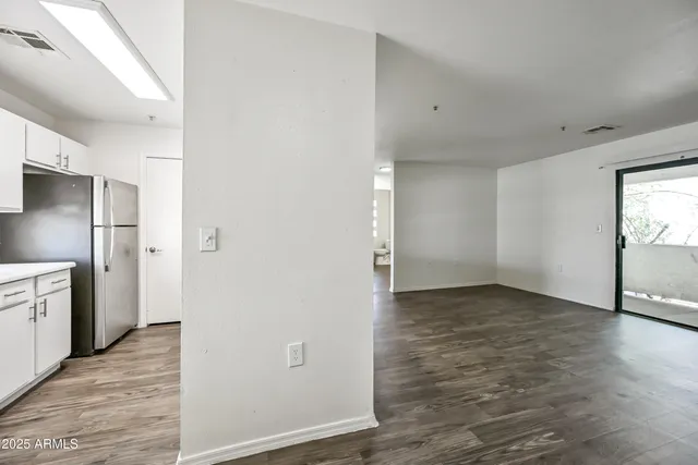 a view of a refrigerator in kitchen and wooden floor