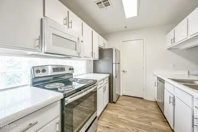 a kitchen with a stove microwave and refrigerator