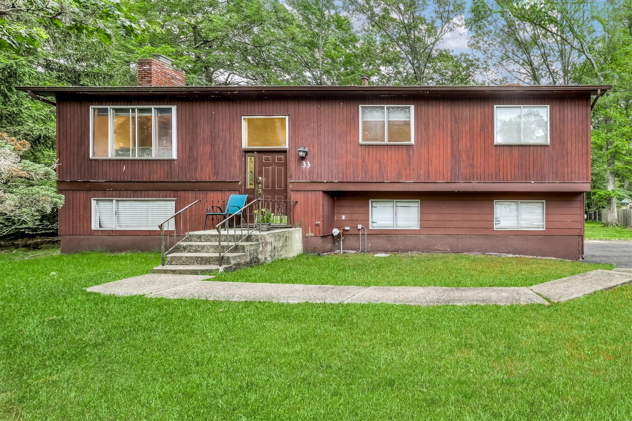 33 Balmoral Drive Chestnut Ridge, NY 10977 - Photo 1 of 1 Raised ranch featuring a chimney and a front yard