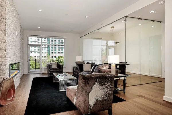 a living room with furniture and a floor to ceiling window
