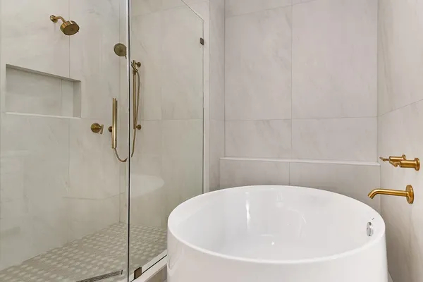 a spacious bathroom with a double vanity sink a large mirror a shower and