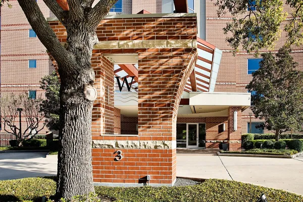 a front view of a building with a tree