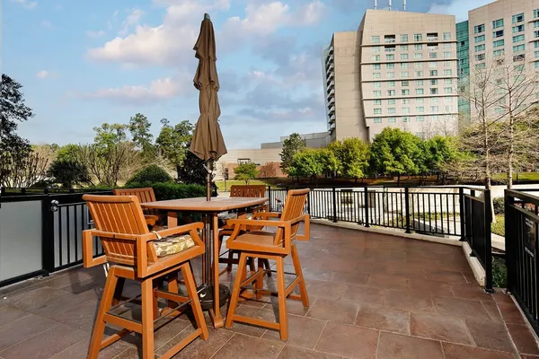 a view of a patio with chairs and plants