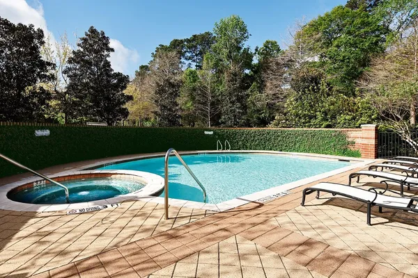 a view of swimming pool with outdoor seating and lake view