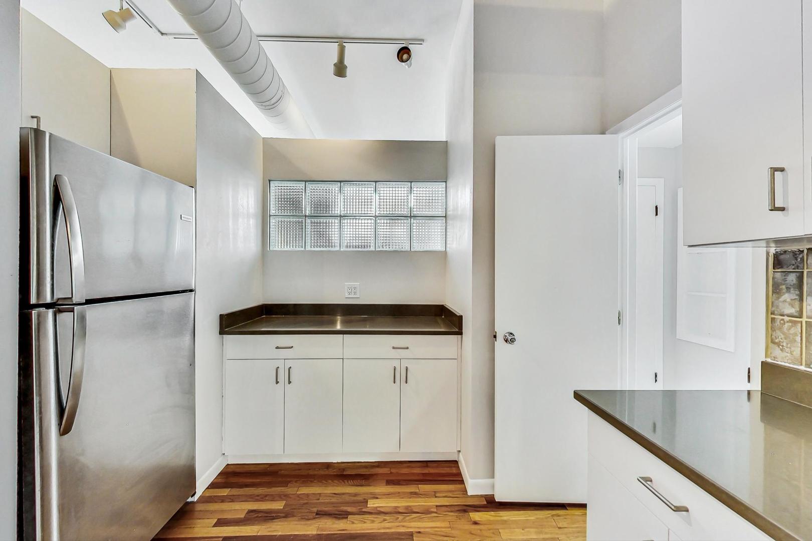 400 North Racine Avenue, Unit 217 Chicago, IL 60642 - Photo 17 of 29 a kitchen with a refrigerator and a sink