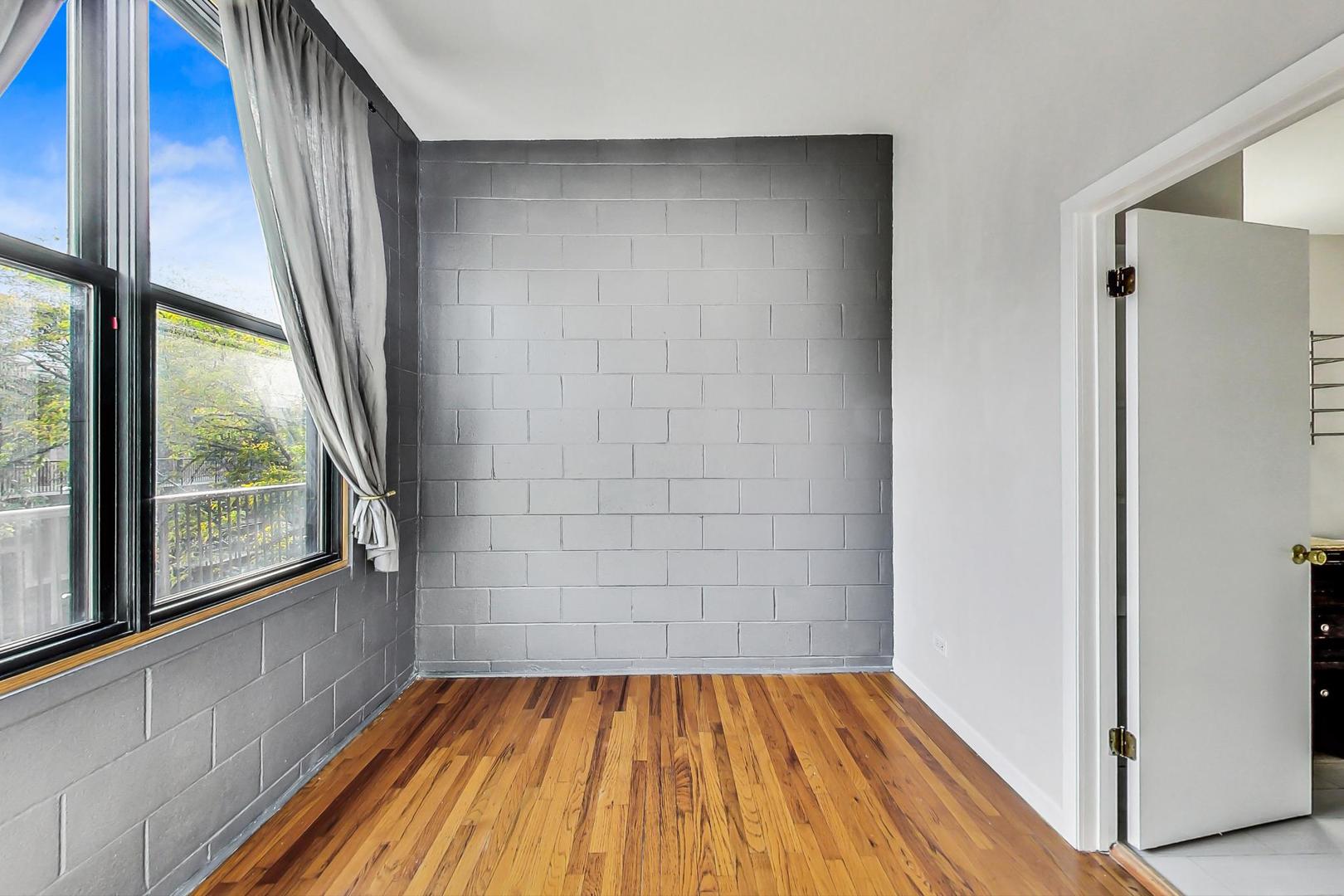 400 North Racine Avenue, Unit 217 Chicago, IL 60642 - Photo 18 of 29 a view of a room with wooden floor and large window
