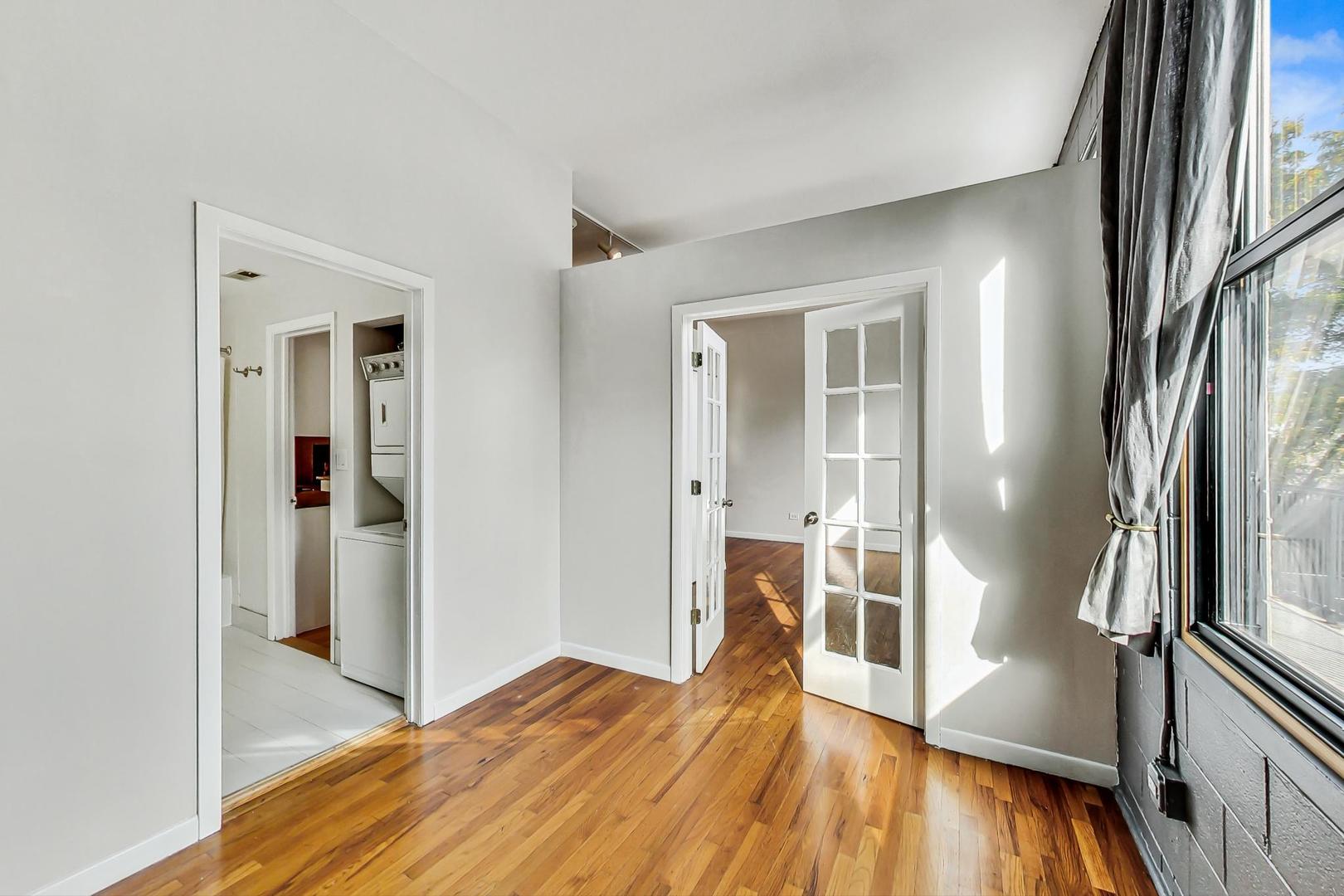 400 North Racine Avenue, Unit 217 Chicago, IL 60642 - Photo 19 of 29 a view of a hallway with wooden floor and a bathroom