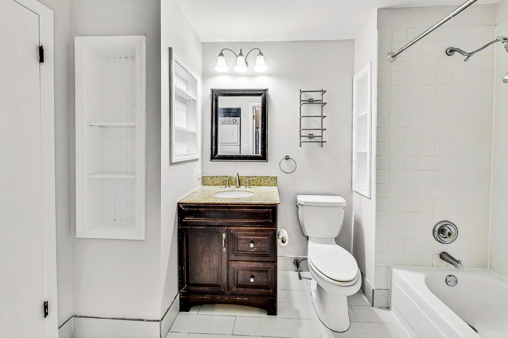 400 North Racine Avenue, Unit 217 Chicago, IL 60642 - Photo 21 of 29 a bathroom with a toilet sink vanity and mirror