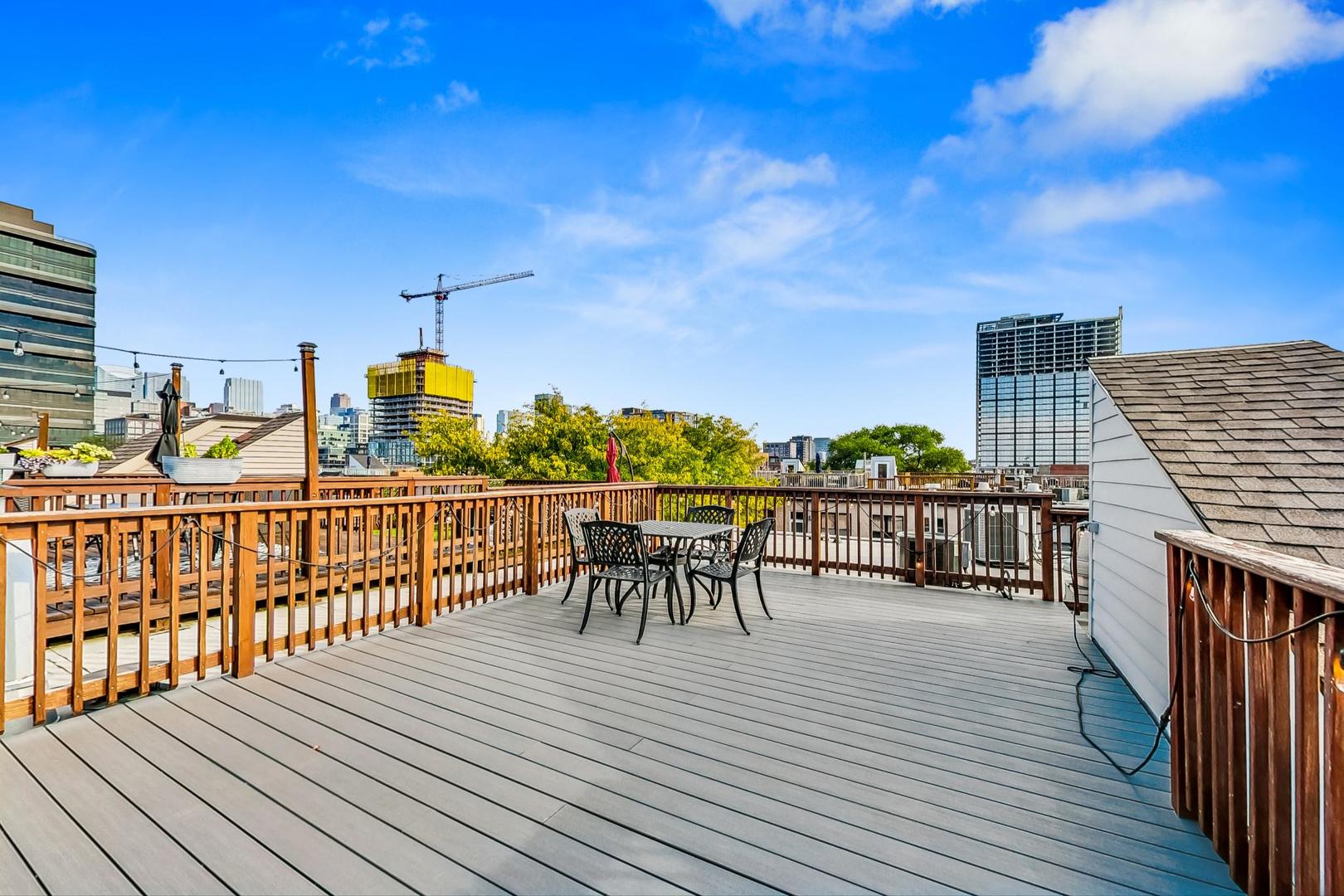 400 North Racine Avenue, Unit 217 Chicago, IL 60642 - Photo 3 of 29 a view of a balcony with chairs and wooden floor
