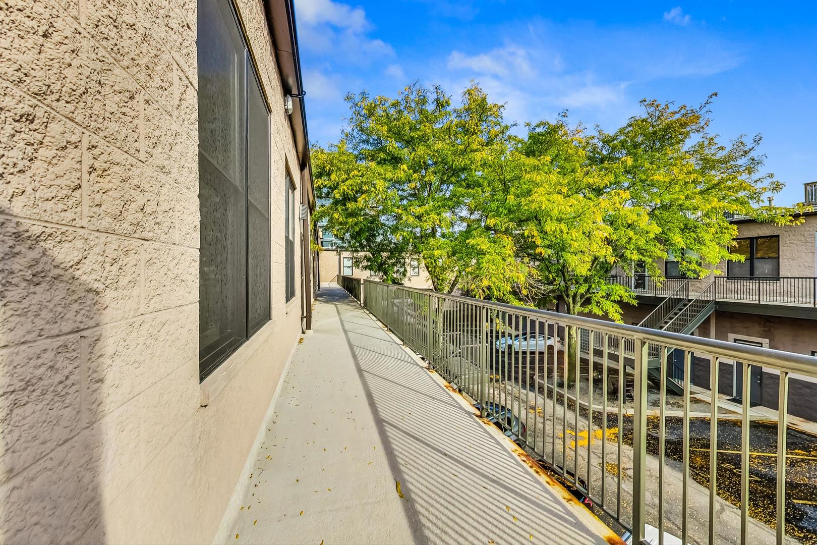 400 North Racine Avenue, Unit 217 Chicago, IL 60642 - Photo 6 of 29 a view of balcony with wooden floor