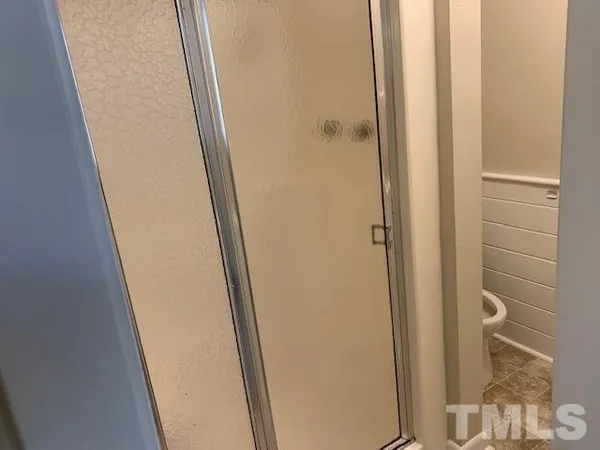 a bathroom with a shower and a door