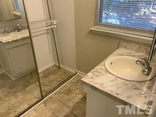 a bathroom with a sink and mirror