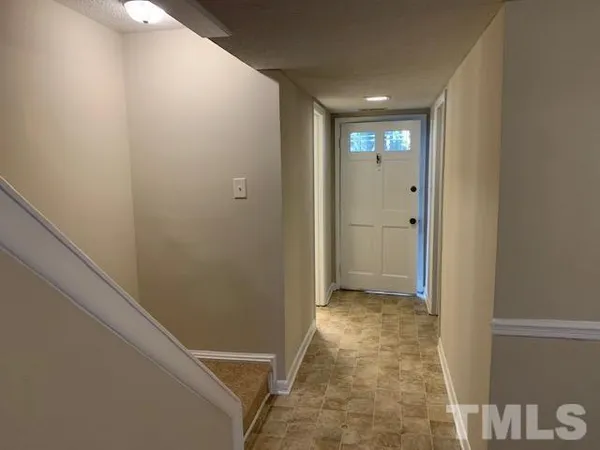 a view of hallway with bathroom