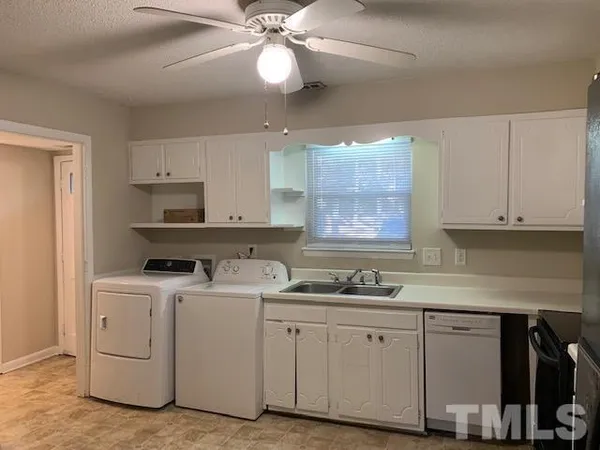a kitchen with cabinets appliances and a window