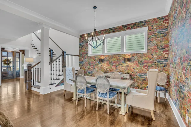 a dining room with furniture and wooden floor