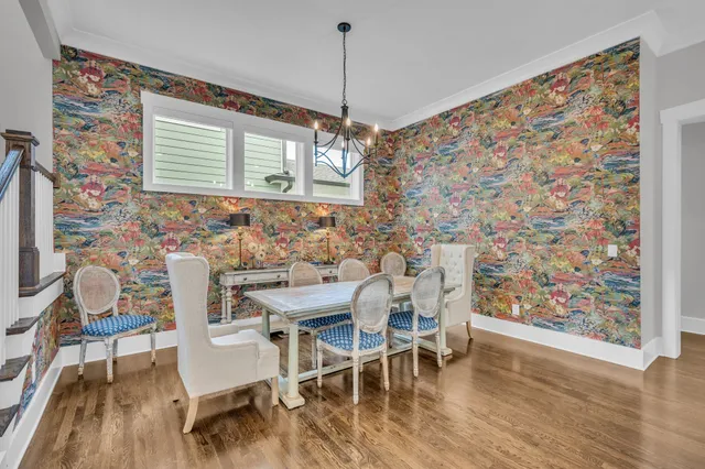 a dining room with furniture and wooden floor