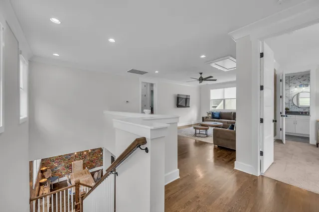 a living room with furniture gym equipment and a ceiling fan