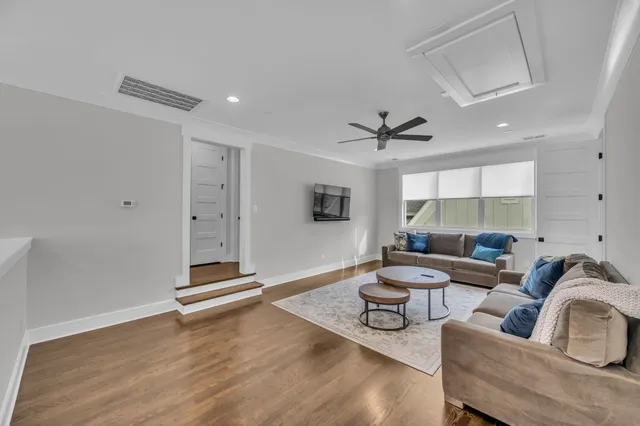 a living room with furniture and a ceiling fan