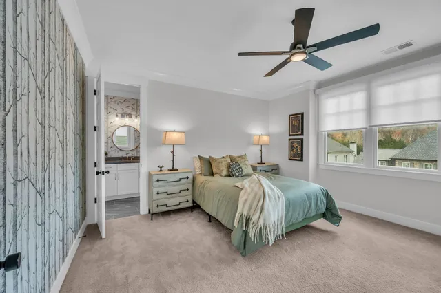 a bedroom with a large bed and a chandelier