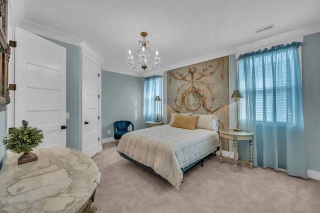 a bedroom with a bed and a chandelier