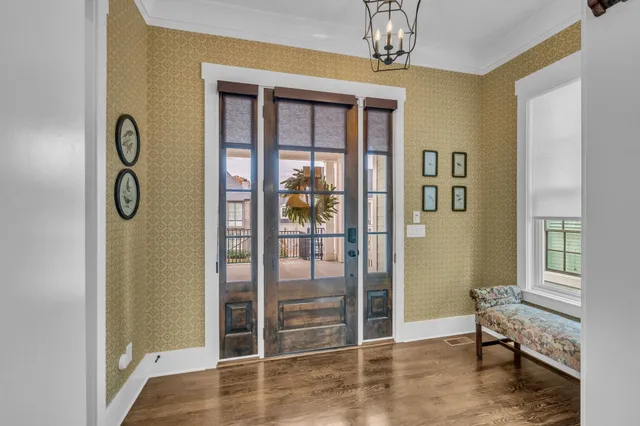 a view of a livingroom with wooden floor and windows