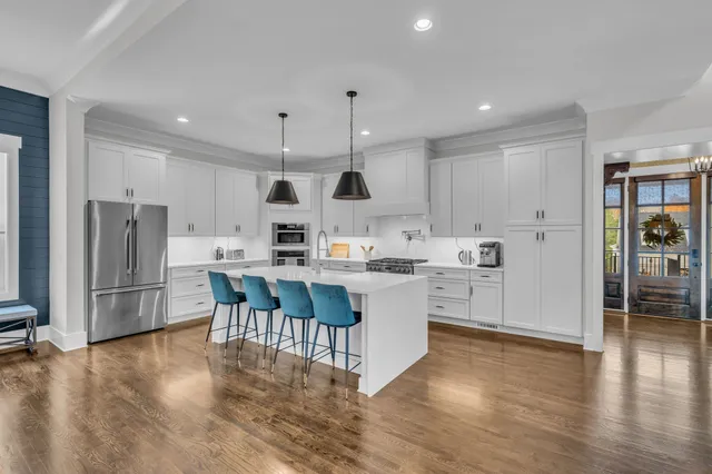 a kitchen with white cabinets and stainless steel appliances