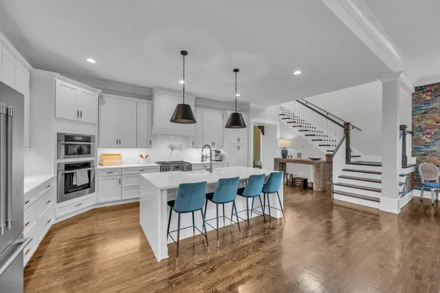 a large kitchen with a table and chairs in it