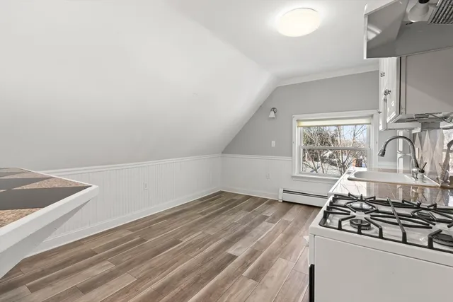a view of a stove top oven sitting inside of a kitchen