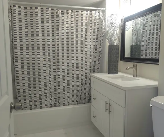 a bathroom with a sink a vanity and a shower