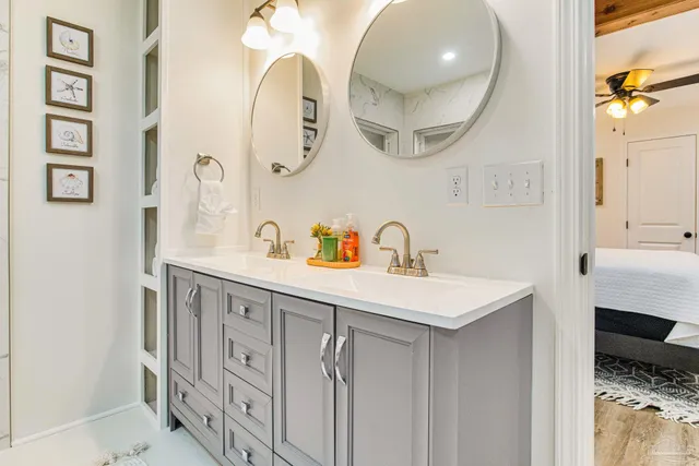 a bathroom with a sink a mirror and a shower