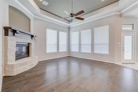 a view of a room with wooden floor and window