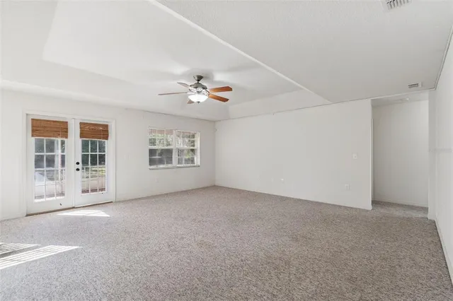 a view of an empty room with a fan