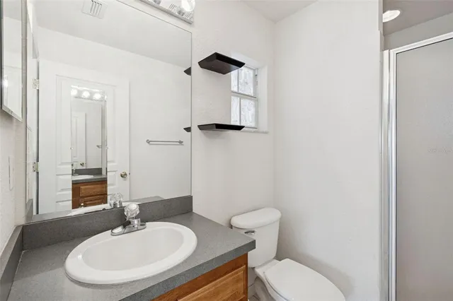 a bathroom with a sink toilet tub and shower