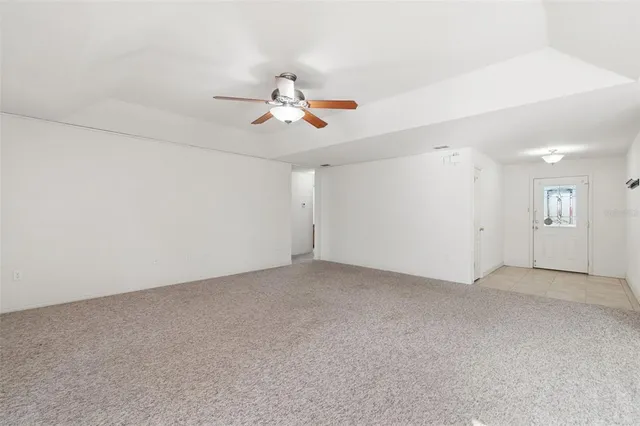 a view of a chandelier fan and entryway