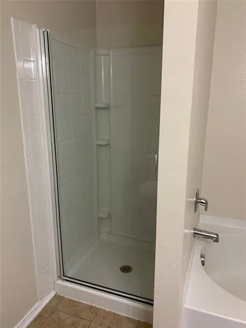 a bathroom with a glass shower door