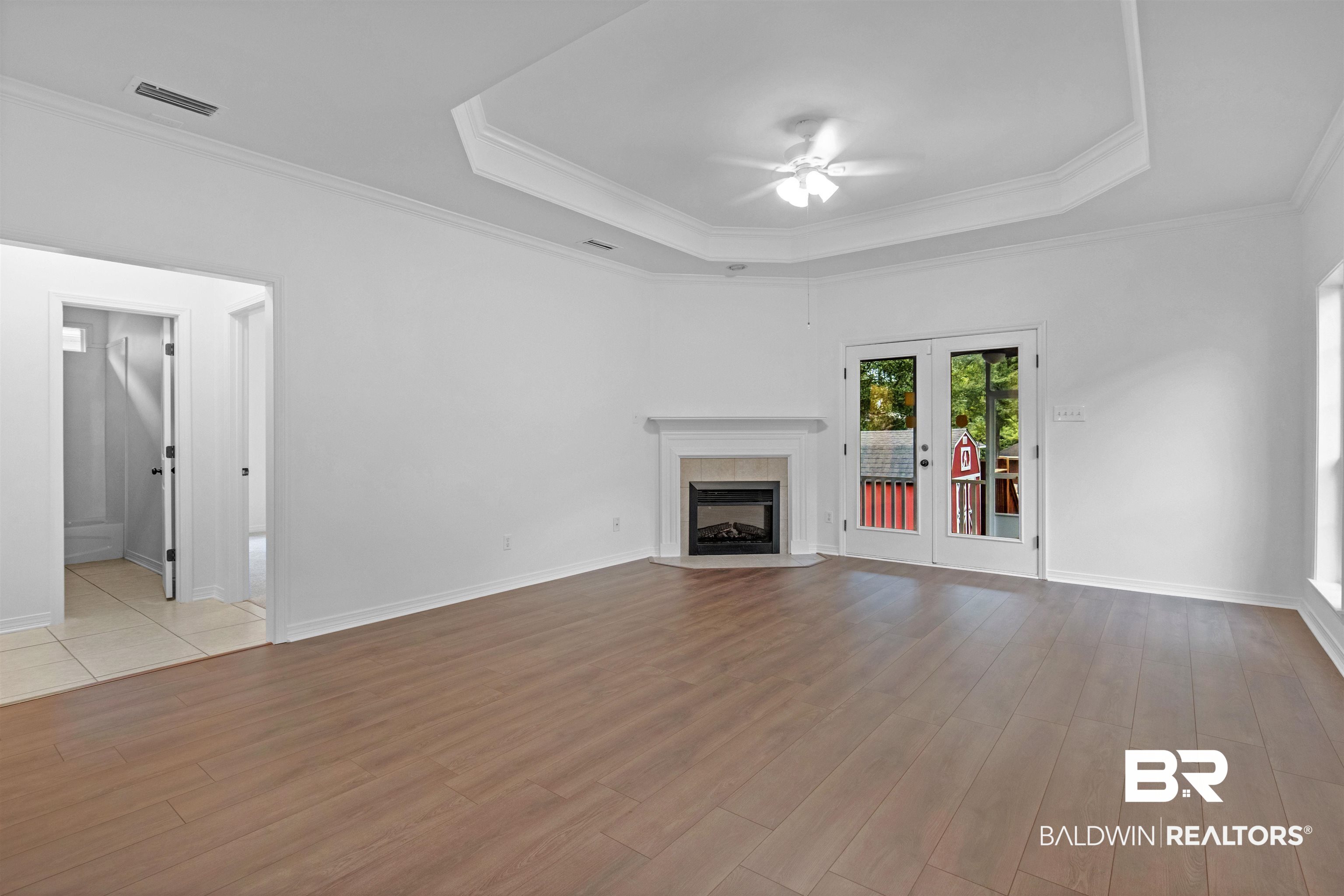 1007 Linlen Avenue Mobile, AL 36609 - Photo 4 of 21 Unfurnished living room featuring light wood-type flooring, ceiling fan, and crown molding