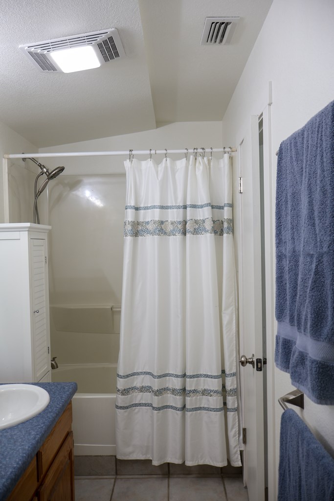1031 Shin Oak Road, Unit 32 Menard, TX 76859 - Photo 16 of 23 a bathroom with a shower and a sink