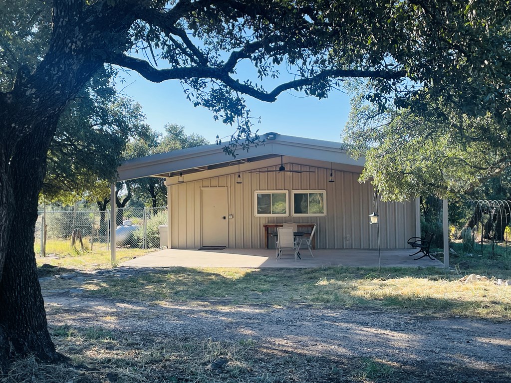 1031 Shin Oak Road, Unit 32 Menard, TX 76859 - Photo 3 of 23 a front view of a house with a yard and garage